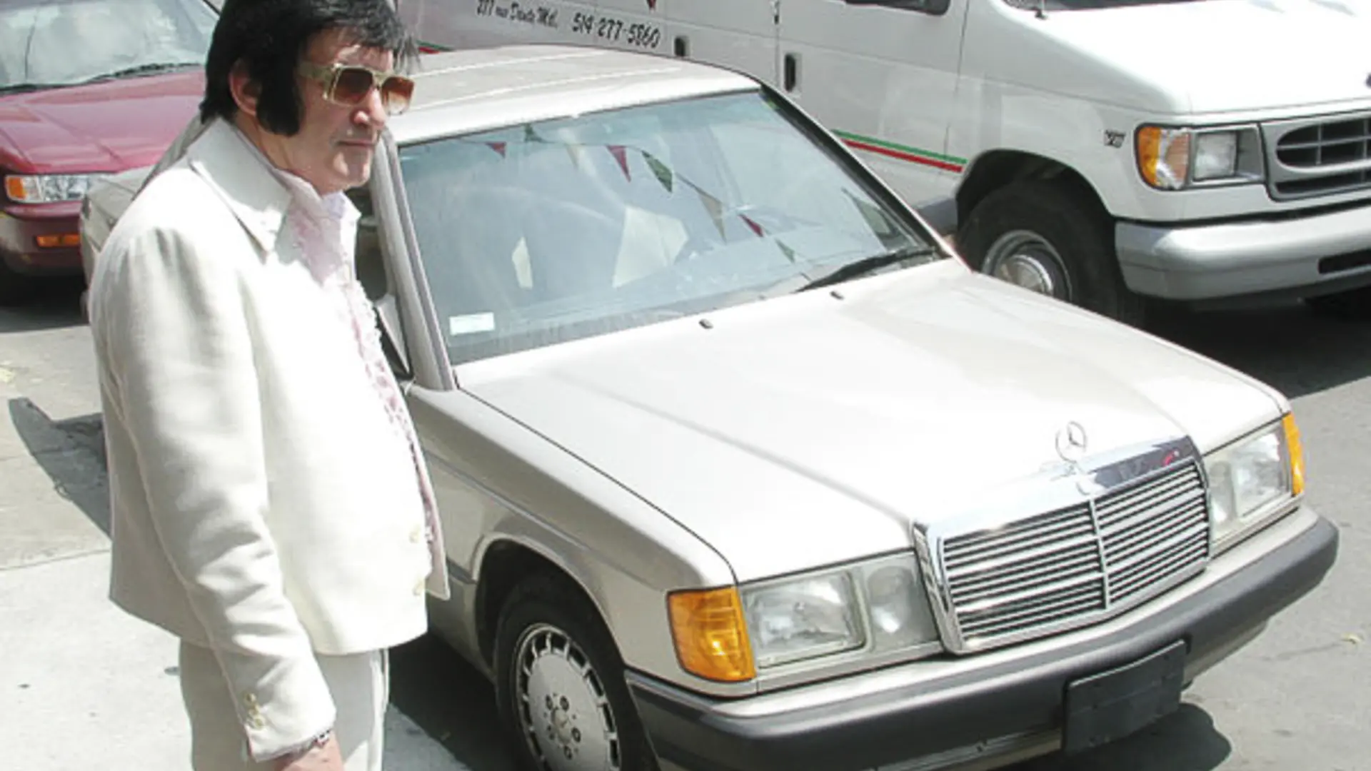Elvis l'italiano - dir. André-Line Beauparlant, an Elvis impersonator stands next to a silver car