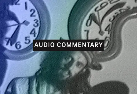 Les Canadiens sont là (Audio Commentary)- dir. Pierre Falardeau and Julien Poulin, close-up of long-haired man with clocks behind him